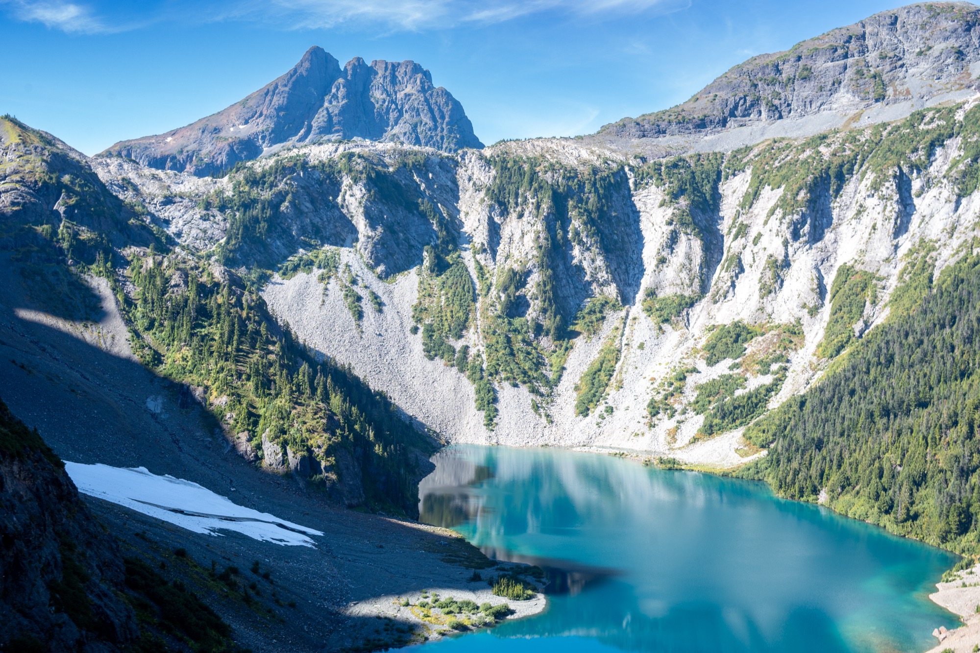 A turquoise glacier lake below a British Columbia peak