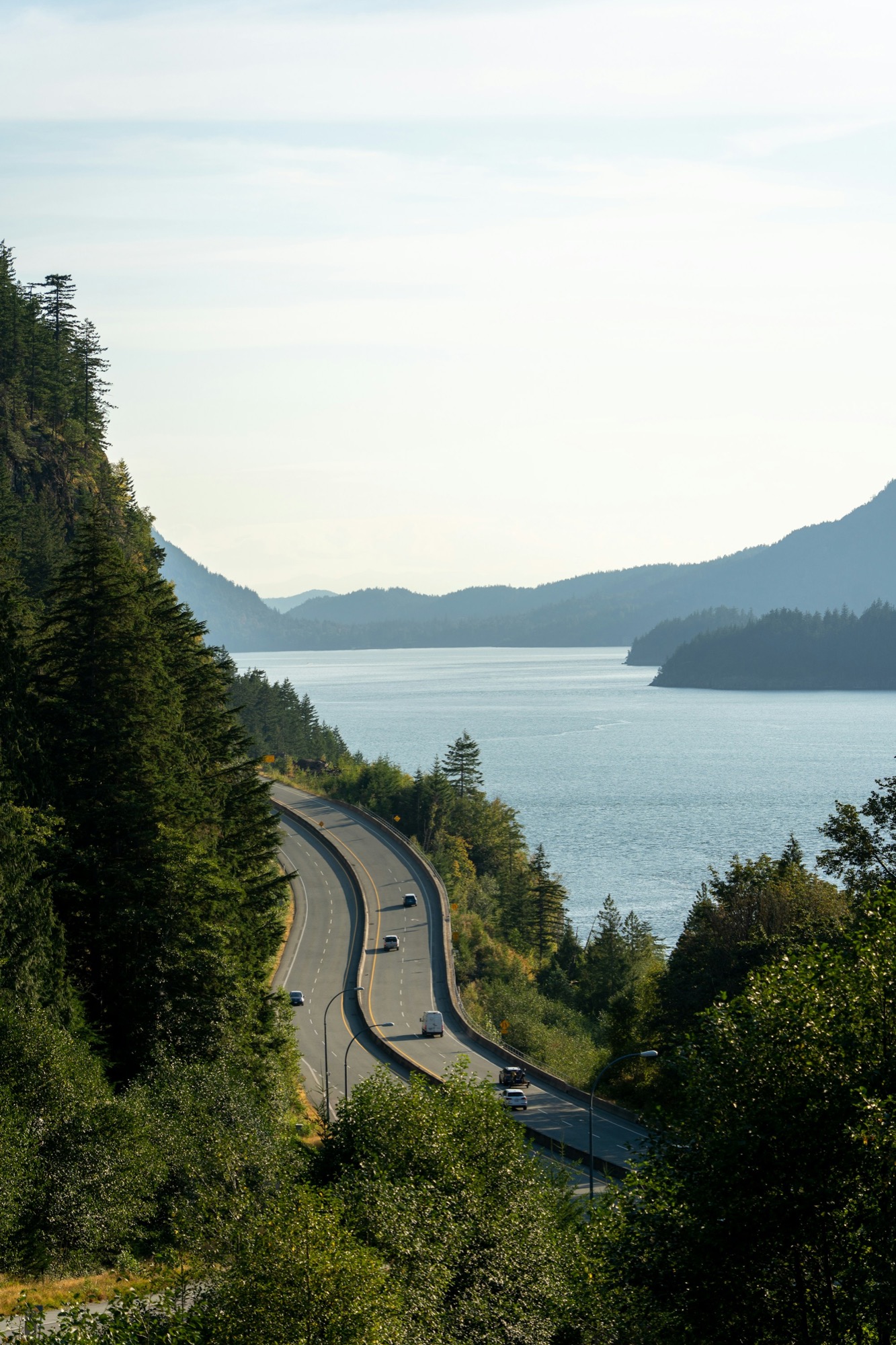Highway winding along the forested coastline of Howe Sound on the Sea to Sky corridor